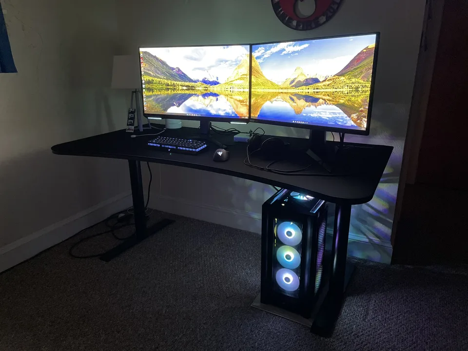 Dual-monitor desk setup with a custom RGB desktop PC built by Foxworx